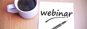 Coffee on the table with note writing webinar.